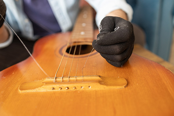 https://pierosmusic.com/wp-content/uploads/2025/04/the-technician-setting-up-the-guitar-in-the-worksh-2025-03-12-23-40-38-utc.jpg